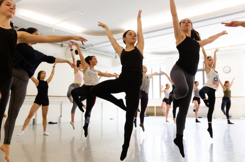Group of dancers in mid-training in a dance studio